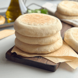 Stack of soft no-knead pita breads on parchment paper