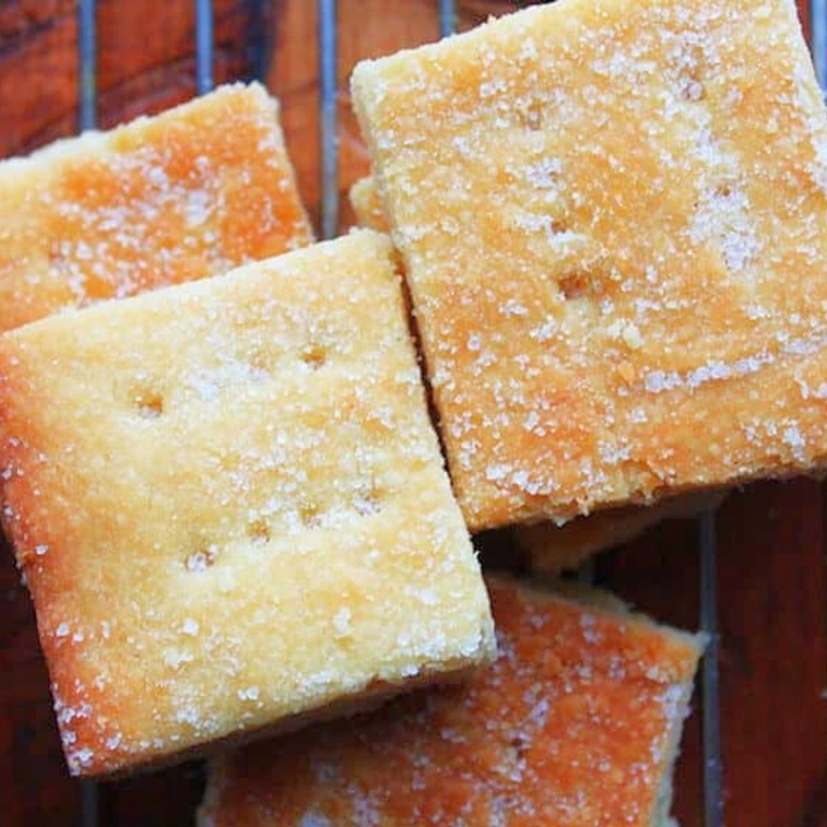 Top view of baked three-ingredient shortbread squares with lightly golden edges and a sugar topping