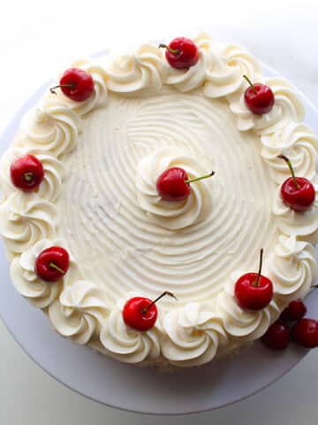 This decadent white Chocolate cake is irresistibly delicious. Filled with white chocolate chips or Chunks and topped with silky white buttercream, it makes an elegant and beautiful bake for any occasion.