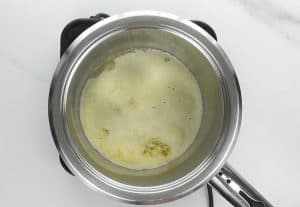As the butter melts it starts to splatter and foam begins to rise to the surface. The splattering means that the water in the butter is evaporating. Continue to simmer the butter until the splattering subsides, about 6-7 minutes.