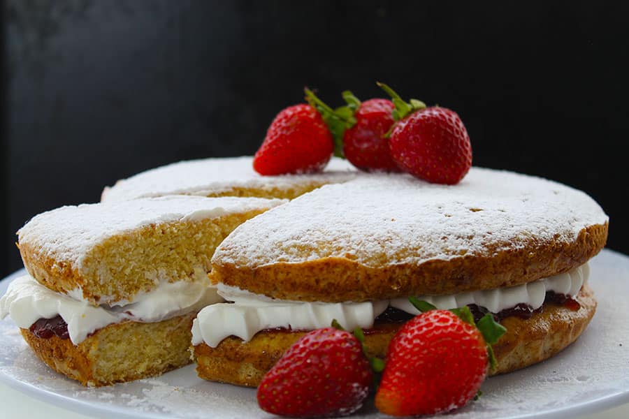 My recipe for Victoria Sponge Cake is the perfect treat for any occasion. Sandwiched with whipped cream and jam, topped with a dusting of powdered sugar, it is elegant simplicity at its best. This version has all the amazing taste of the classic Victoria sponge, but it's made without eggs and butter.