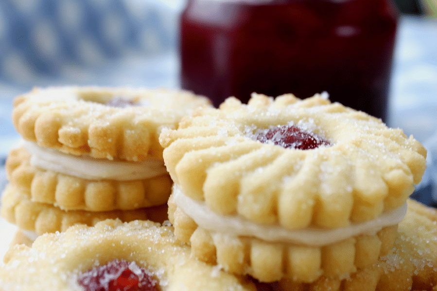 My regular 3 ingredient butter cookie recipe just got glorified into stunning Strawberry Butter Cookies. They are light, crisp, and super easy to make. Sandwiched together with jam and buttercream creating an impressively beautiful batch of cookies.