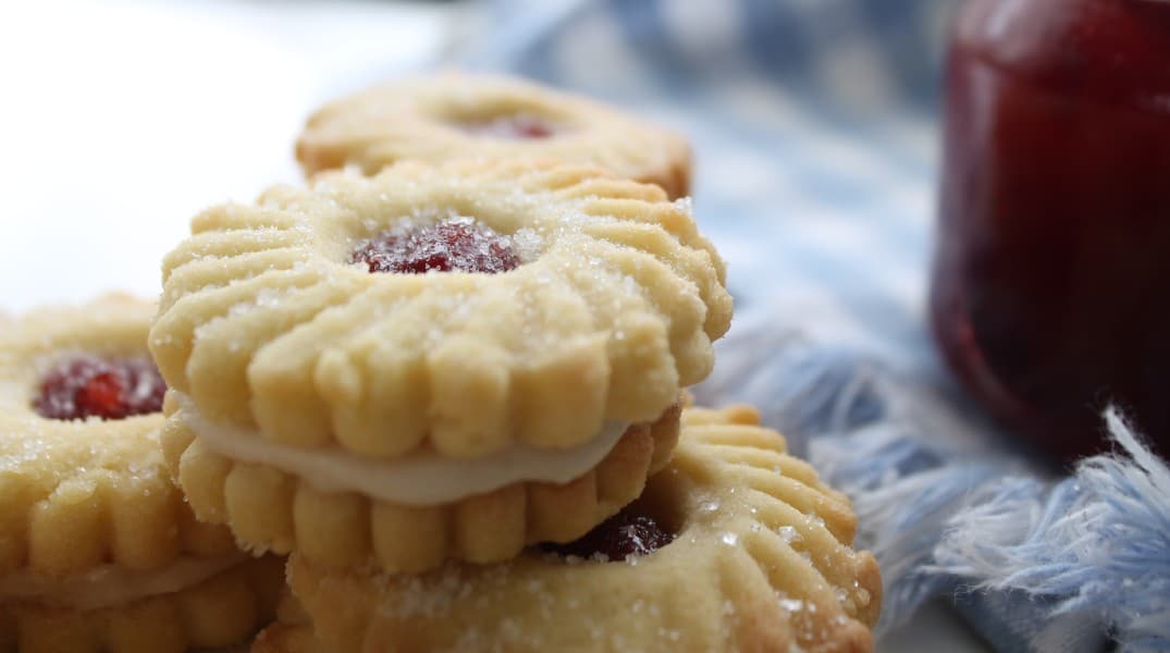 My regular 3 ingredient butter cookie recipe just got glorified into stunning Strawberry Butter Cookies. They are light, crisp, and super easy to make. Sandwiched together with jam and buttercream creating an impressively beautiful batch of cookies.