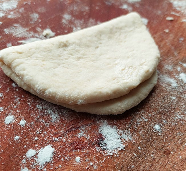 Fold the dough in half, with the oiled part on the inside.
