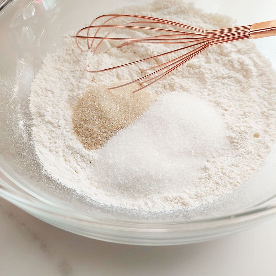 In a large bowl, whisk together flour, granulated sugar, brown sugar, baking soda and salt. 