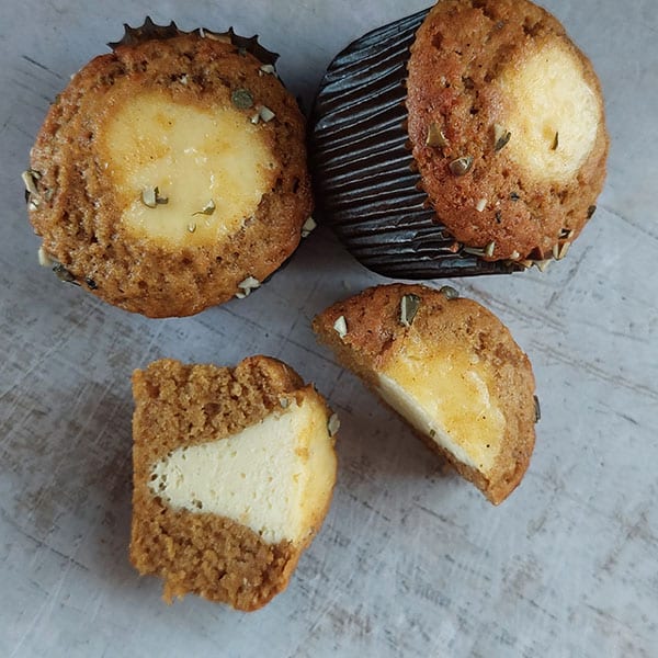 Filled and topped with a piping of cheesecake batter offers tangy balance to the sweet pumpkin muffins. 