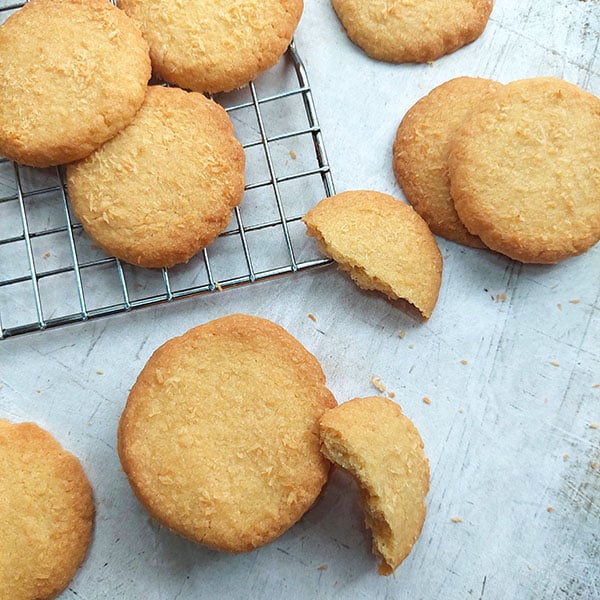 Coconut Butter cookies in half on cooling rack
