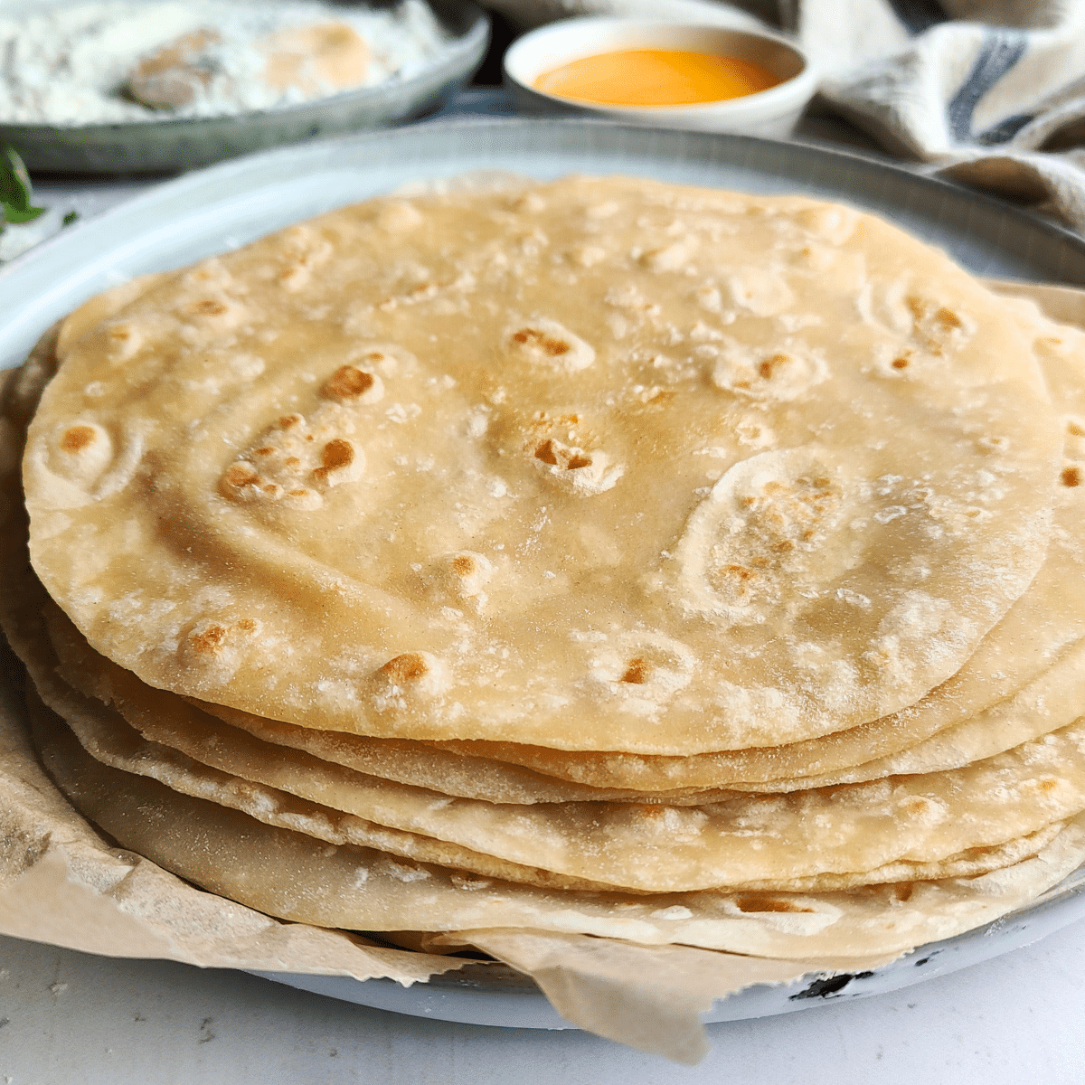 Stack the flatbreads as you cook and cover them with a paper towel or tea towel. This maintains their softness and flexibility.