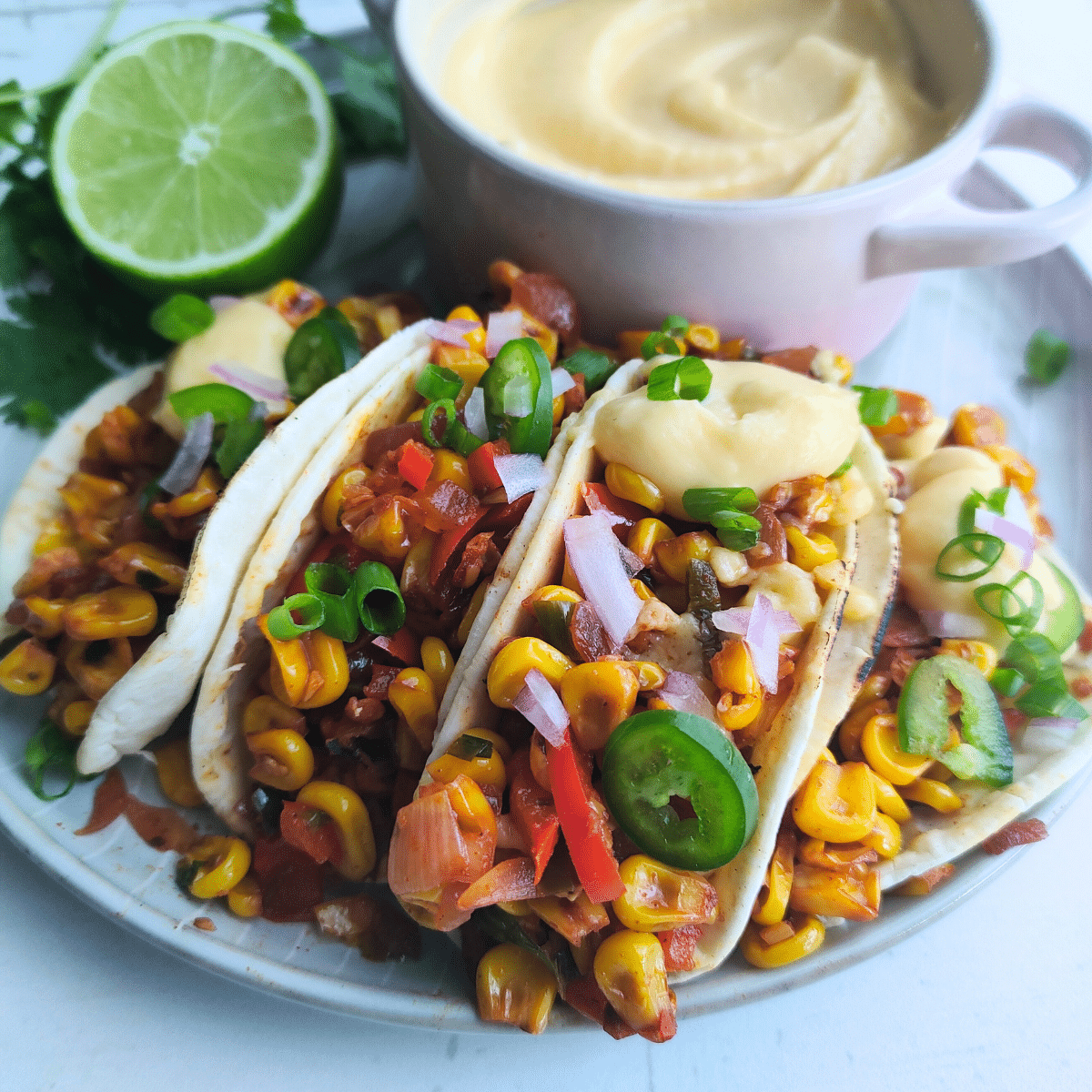 Spicy Corn and cheese tacos topped with cheese sauce
