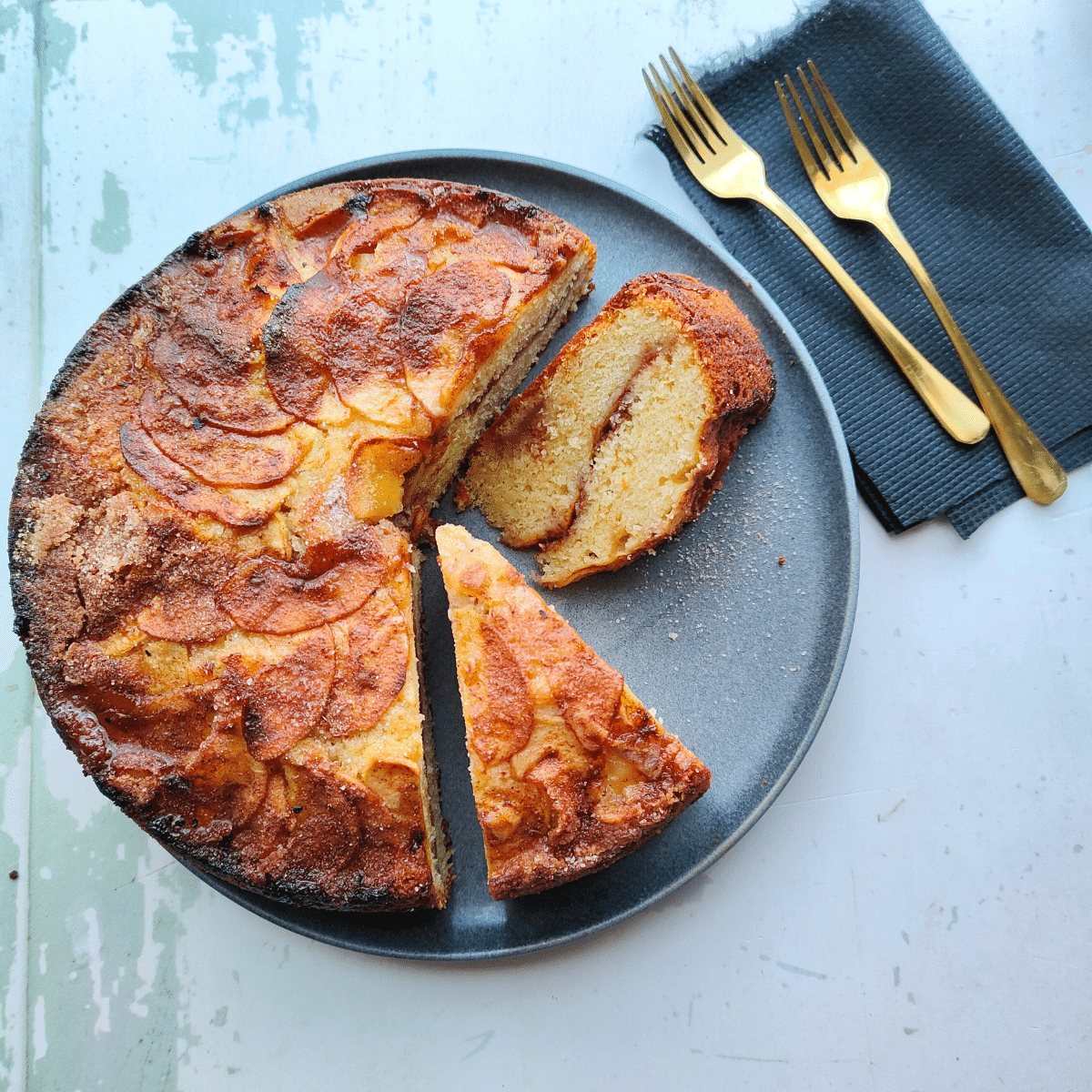 Danish Cinnamon Apple Cake, a delicious buttery cake filled and topped with slices of apples and cinnamon sugar. 