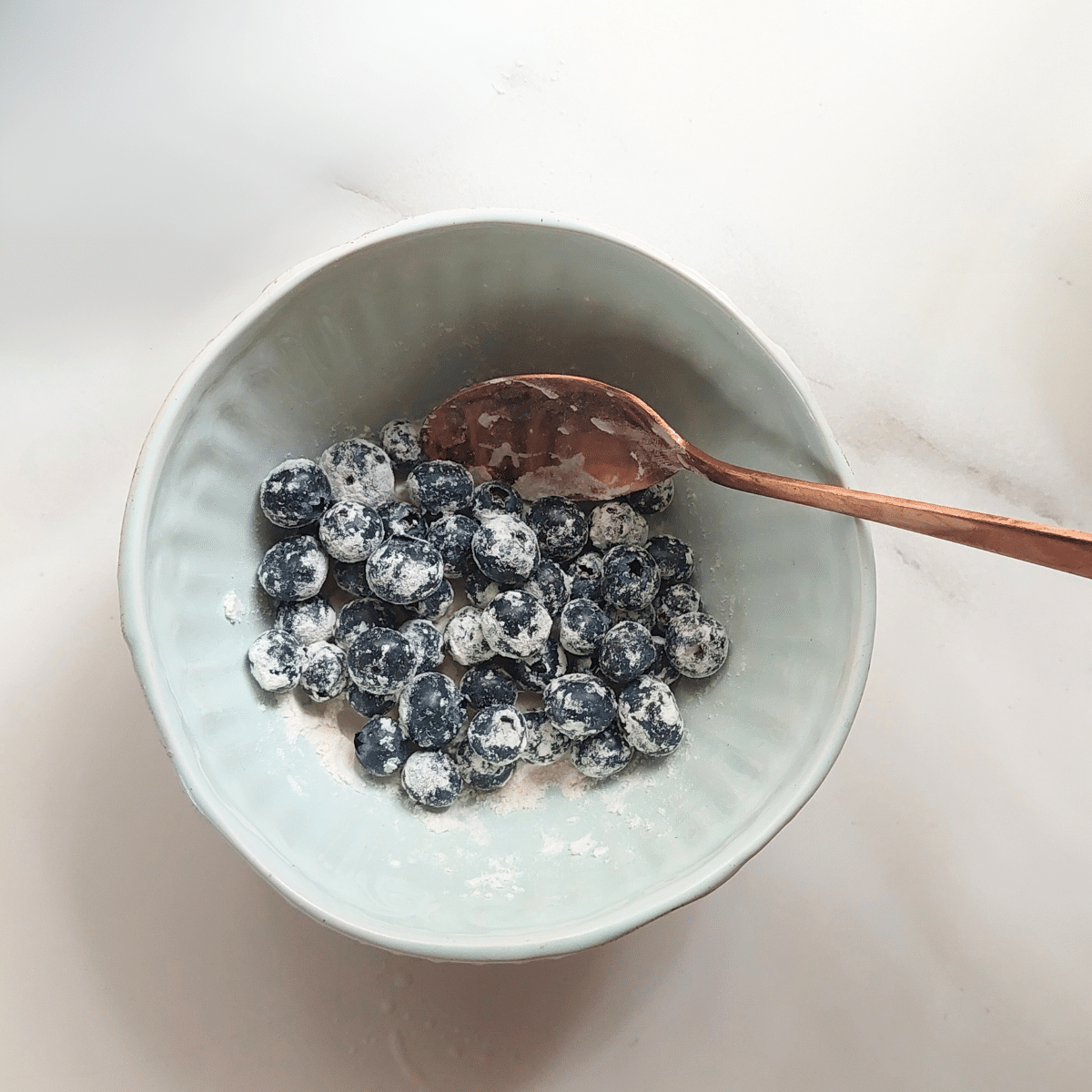 Toss blueberries in 1 teaspoon flour