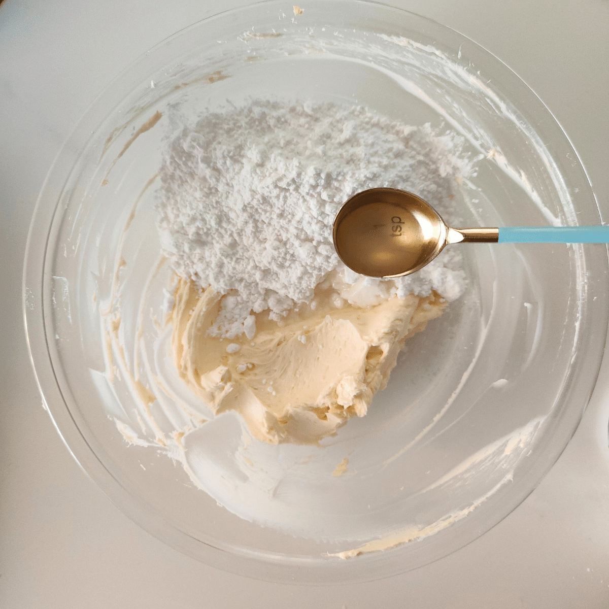 Beat and add powdered sugar and lemon juice and zest