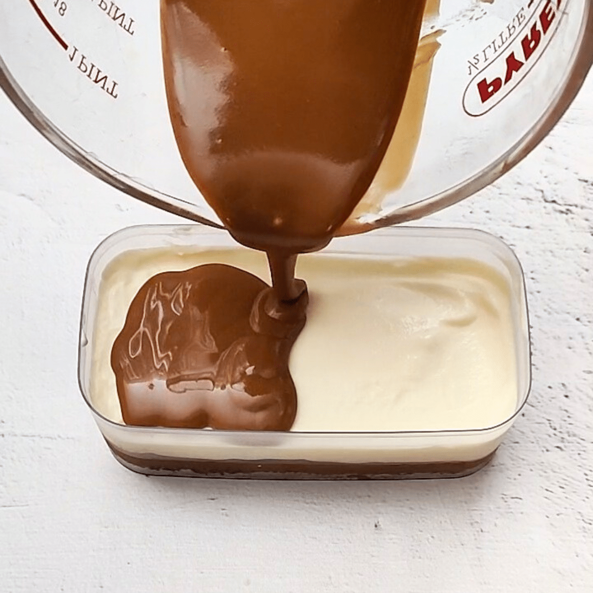 pour melted biscoff spread over cream