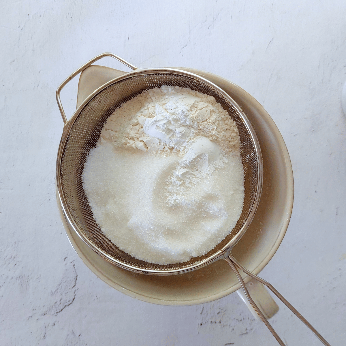 Sift the flour, sugar, salt, and baking powder (if using plain flour) into the bowl with the melted butter mixture,