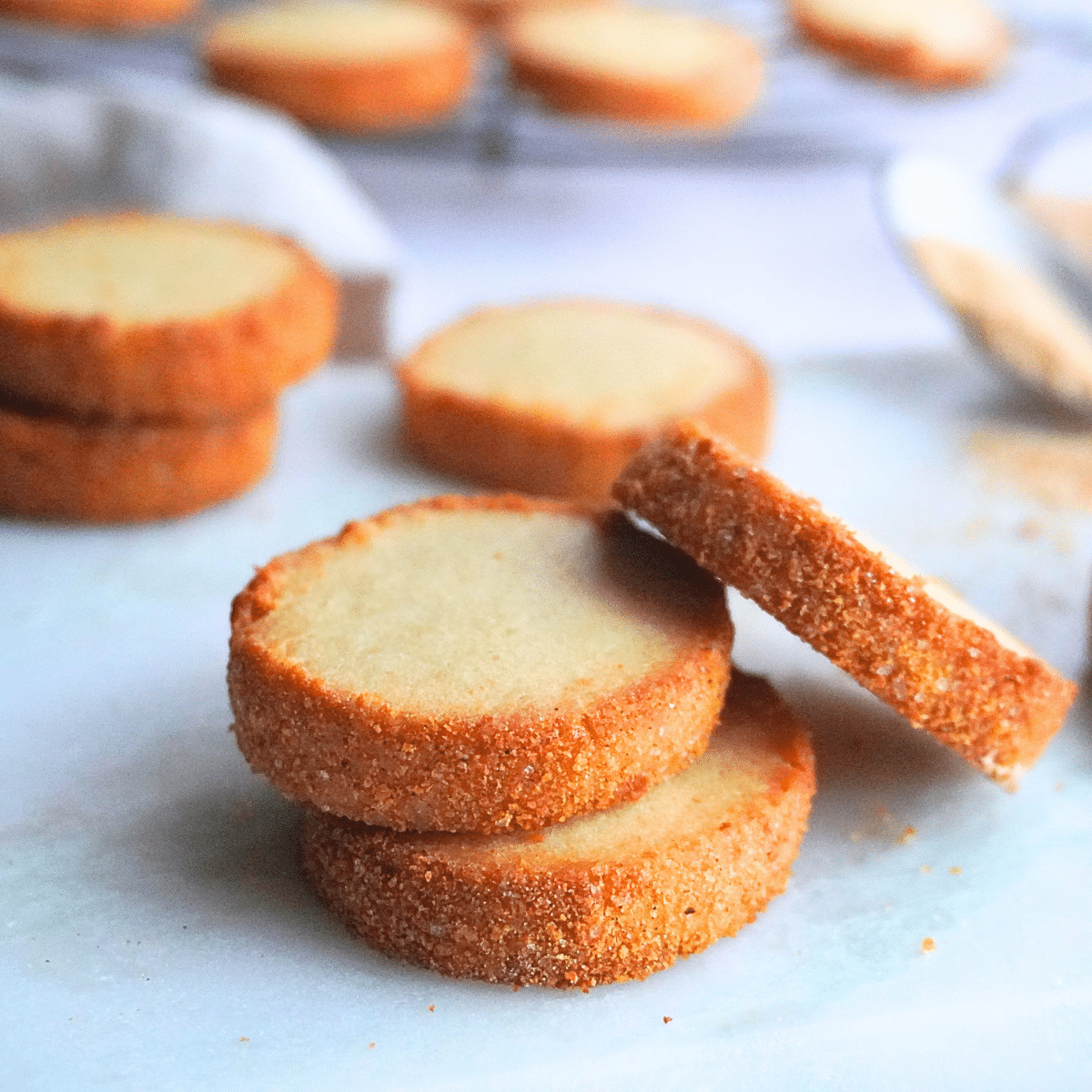Stacked sour cream butter cookies showing off their crispy, golden edges.