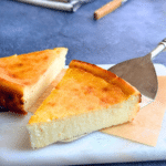 Slice of lemon ricotta semolina cake with a soft, creamy center and golden top, served on a marble board.
