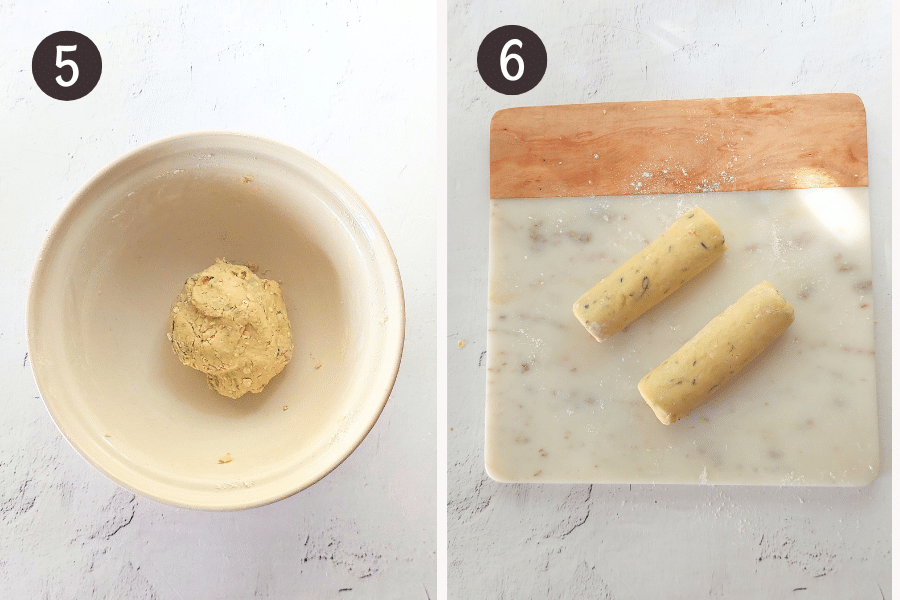 Cookie dough shaped into two short logs on a board, ready to be wrapped and frozen