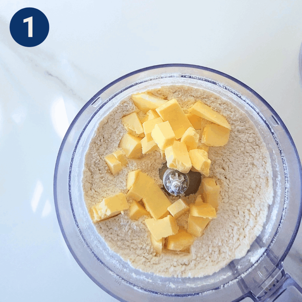 Flour, baking powder, sugar, and cubed butter in food processor