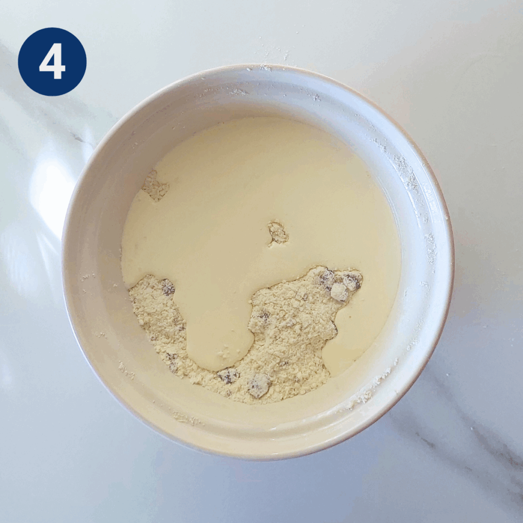 Cream poured over flour and cranberry mixture