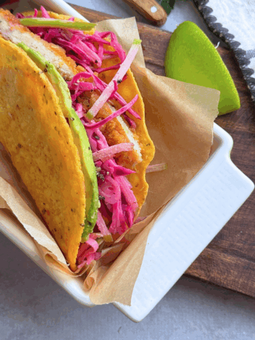 Crispy chicken taco in a corn tortilla with apple slaw and avocado