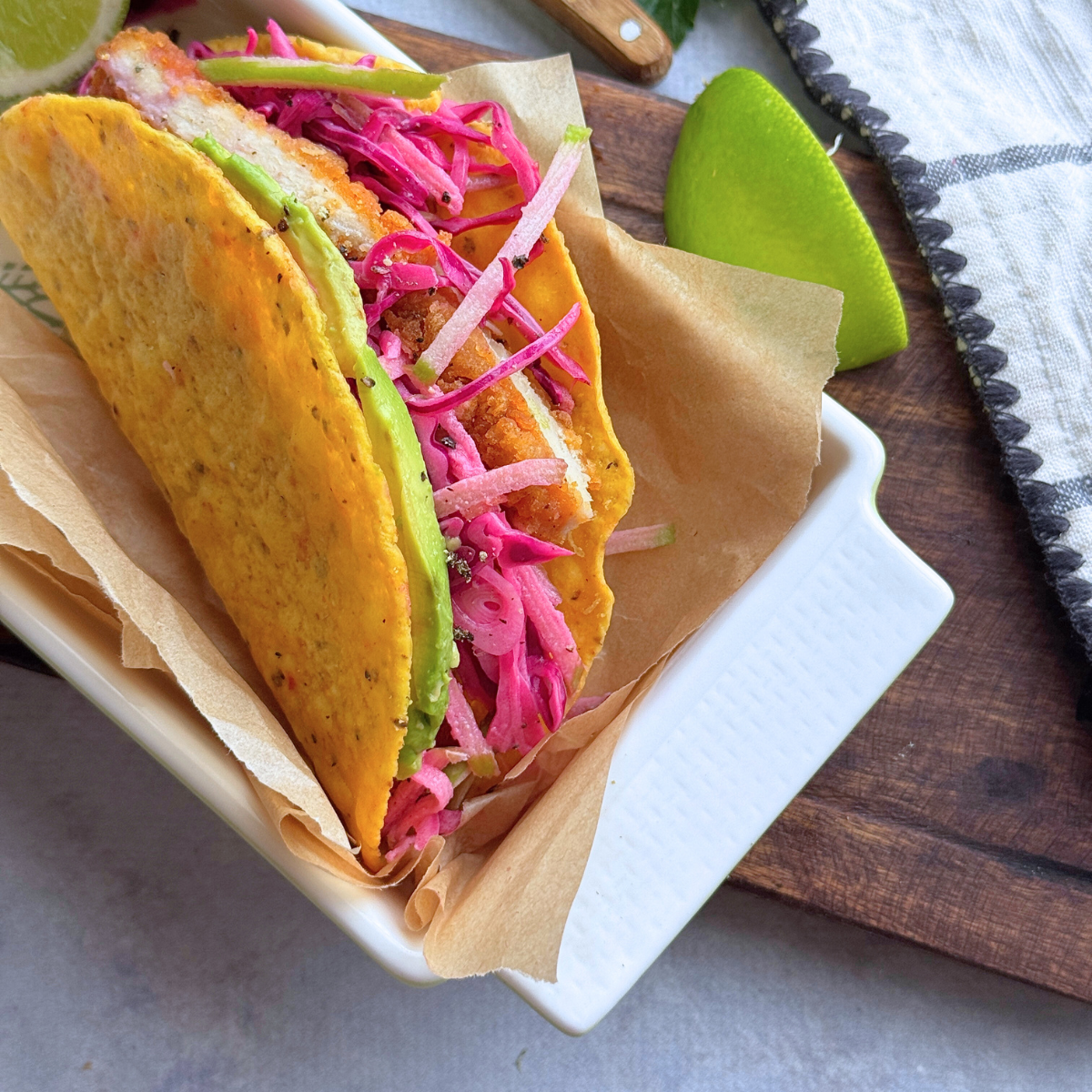 Crispy chicken taco in a corn tortilla with apple slaw and avocado