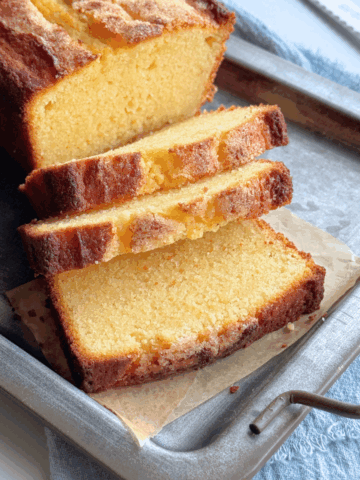 Sliced sour cream pound cake showing soft buttery crumb and golden sugar crust