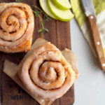 Glazed no yeast apple cinnamon roll showing golden spiral and shiny glaze