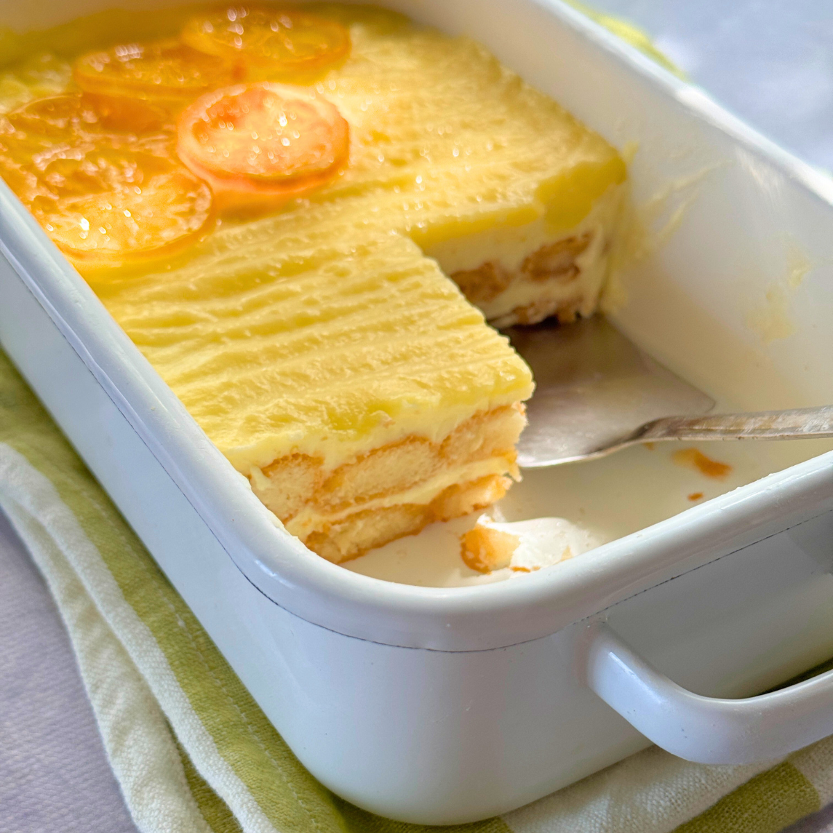 yogurt lemon tiramisu in pan with slice missing