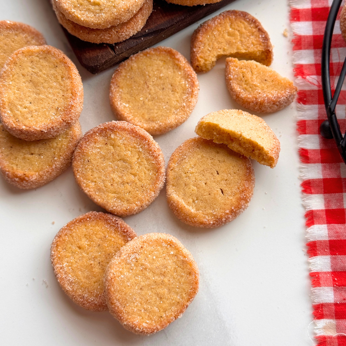 Pumpkin butter cookies with crisp sugar edges and a tender center, one broken to show texture.