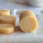 Perfectly round cookie dough log sliced into even pieces with no flat sides