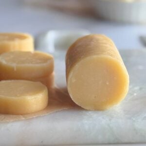 Perfectly round cookie dough log sliced into even pieces with no flat sides