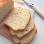 Soft and airy no knead bread slices stacked showing light crumb