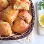 Quick no-knead garlic butter potato rolls in a basket with a soft, fluffy interior.