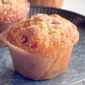 Fresh or frozen strawberry muffins with crisp sugar tops and rounded domes.