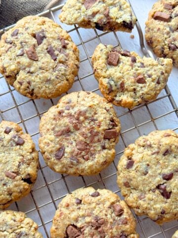 Soft chocolate chip oat cookies on cooling rack